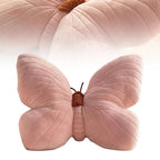 Pink butterfly-shaped pillow with a white background