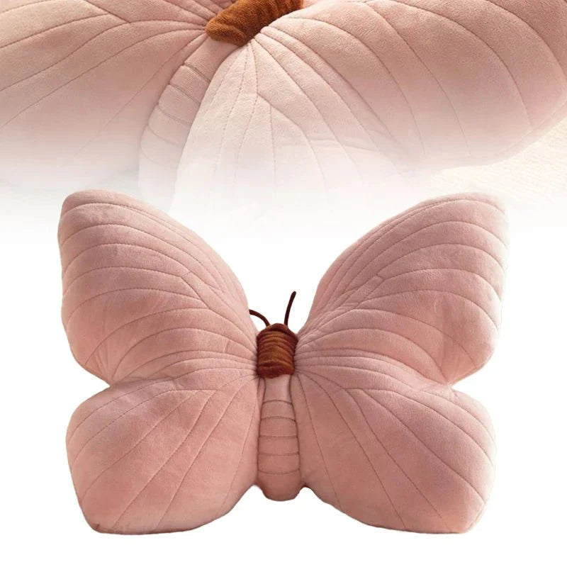Pink butterfly-shaped pillow with a white background