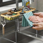 Kitchen sink caddy with cleaning tools and a hand holding a cloth.