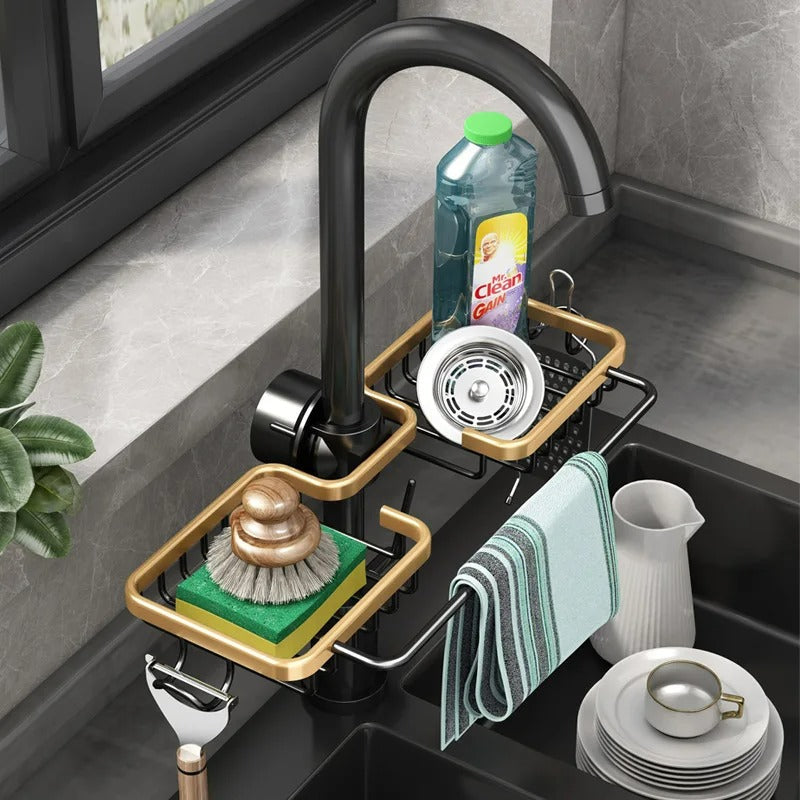 Modern kitchen sink with black faucet, dish soap, sponge, and towel holder.