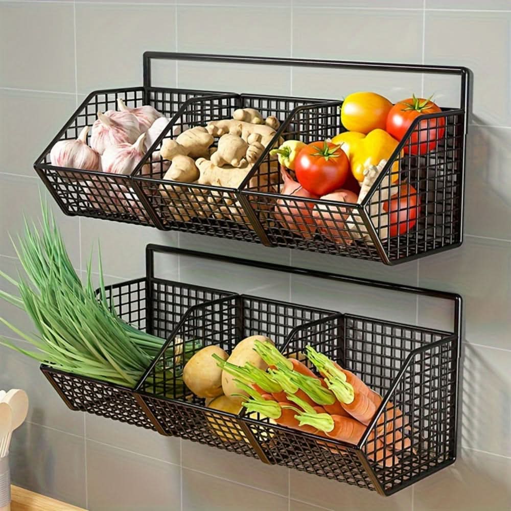 Black wire wall-mounted baskets filled with vegetables on a tiled wall.