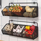 Two black wire baskets with vegetables on a tiled wall.
