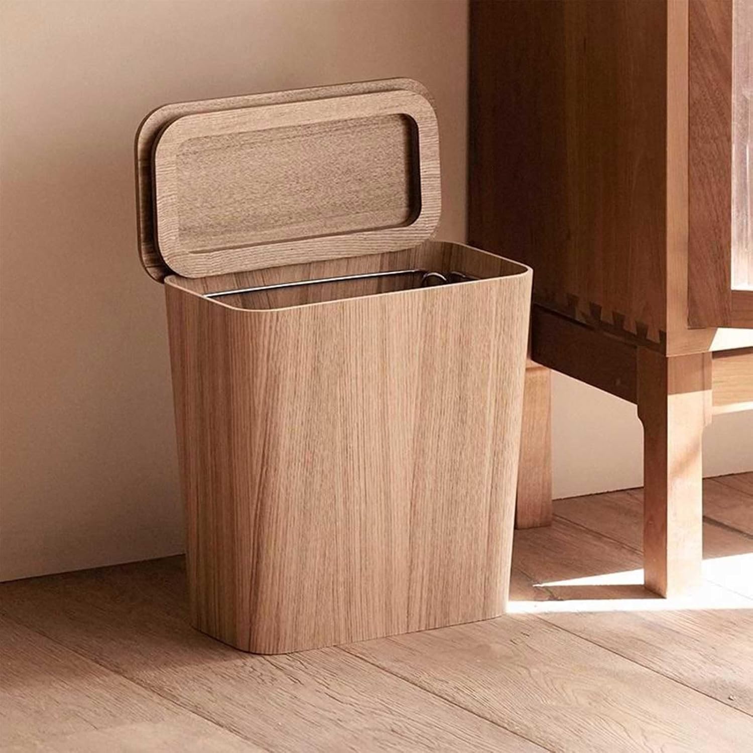 Wooden trash bin with open lid on a wooden floor