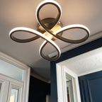 Modern ceiling light fixture in a room with white walls and blue door.