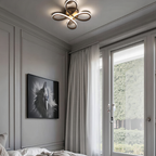Modern bedroom with ceiling light fixture, wall art, and large window.