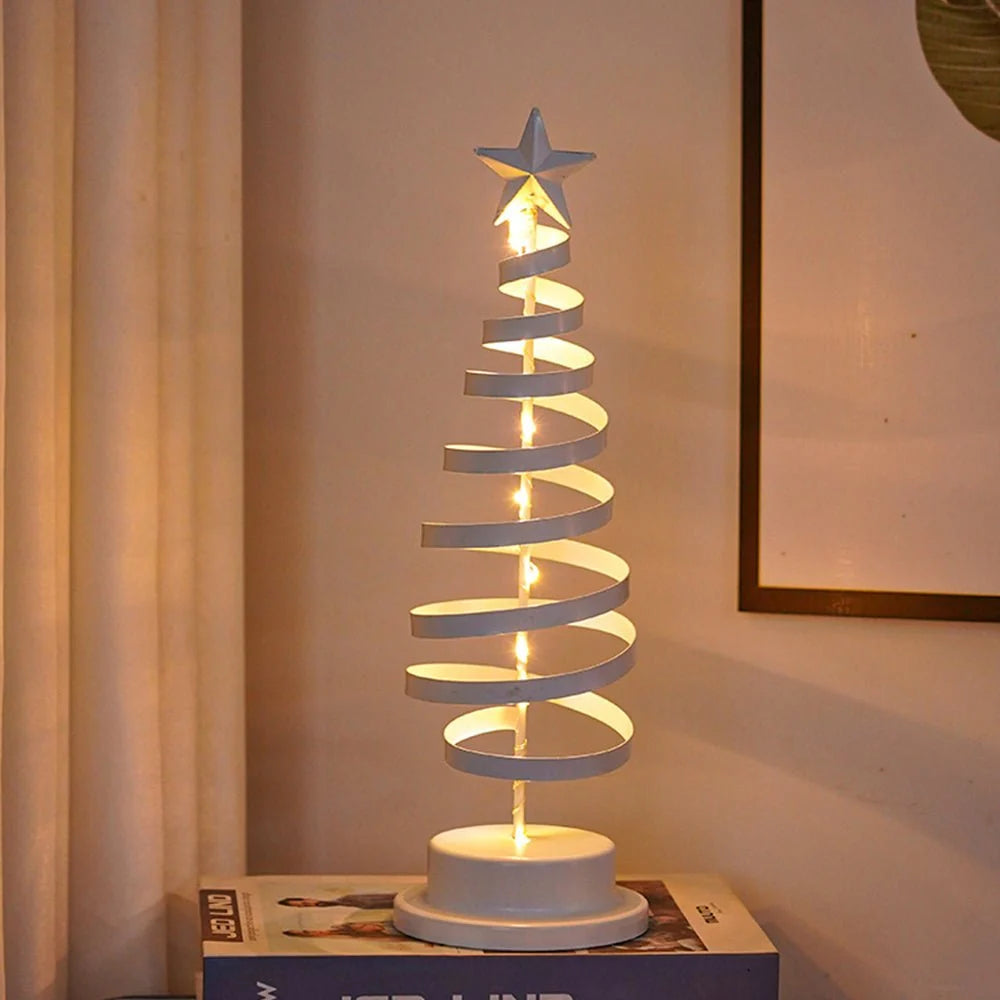 Decorative spiral lamp with a star on top, placed on a surface with a neutral background.