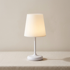White table lamp with a beige shade on a neutral background