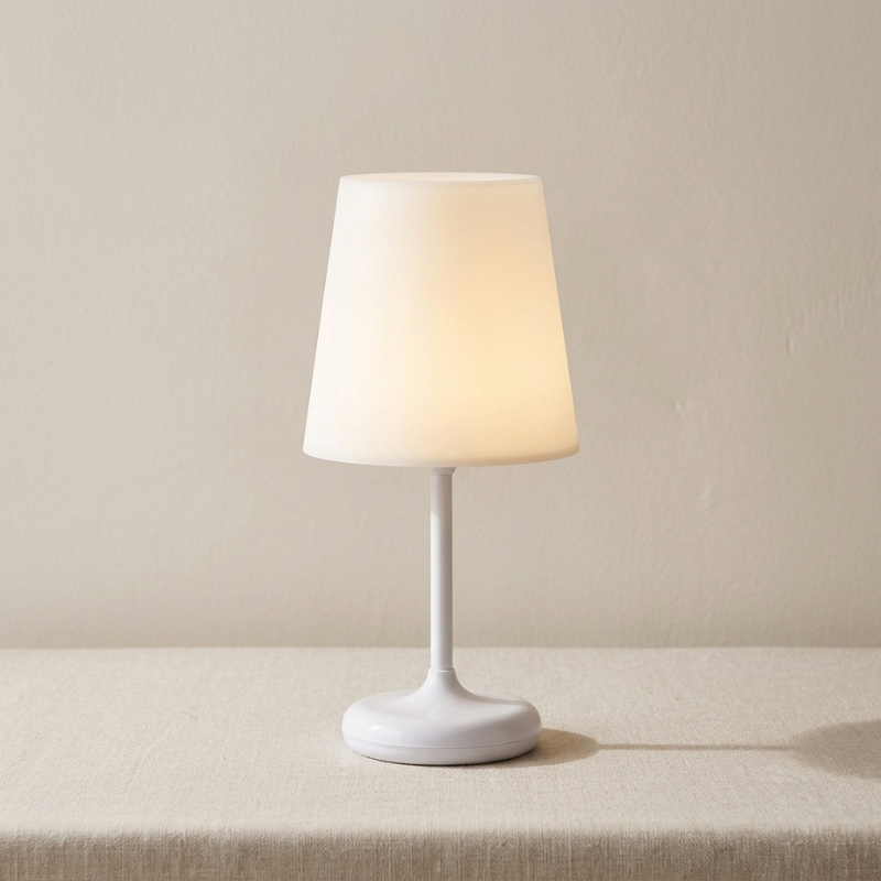 White table lamp with a beige shade on a neutral background