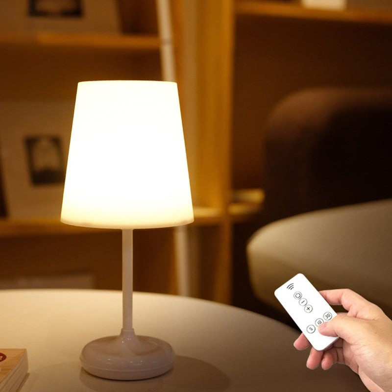 Table lamp with remote control on a surface, blurred background