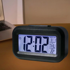 Digital clock with time display on a wooden surface