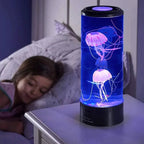 Lava lamp with jellyfish design on a bedside table next to a sleeping child.