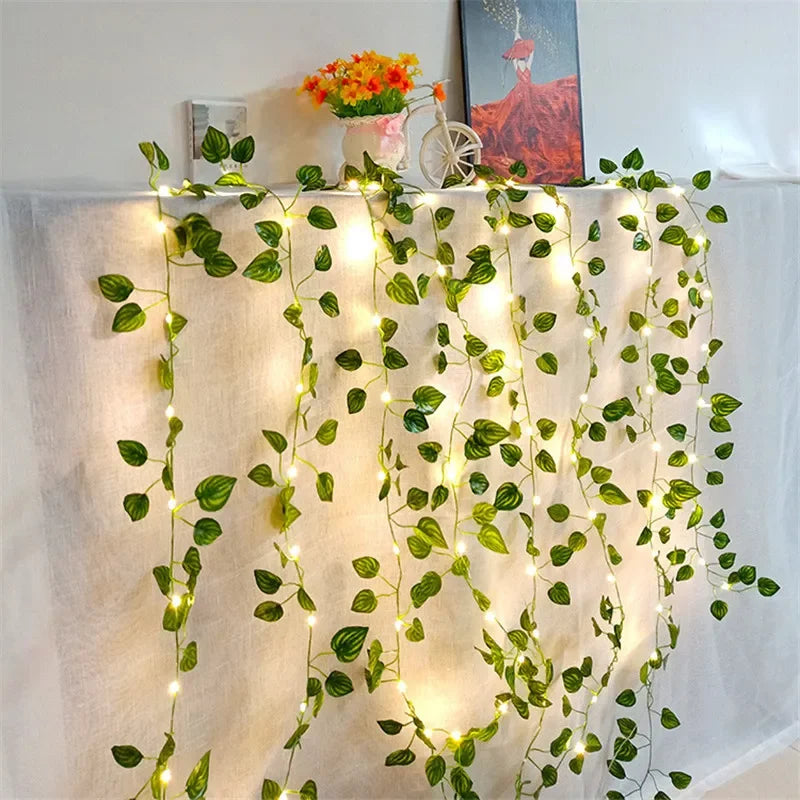 Decorative string lights with green leaves on a white curtain