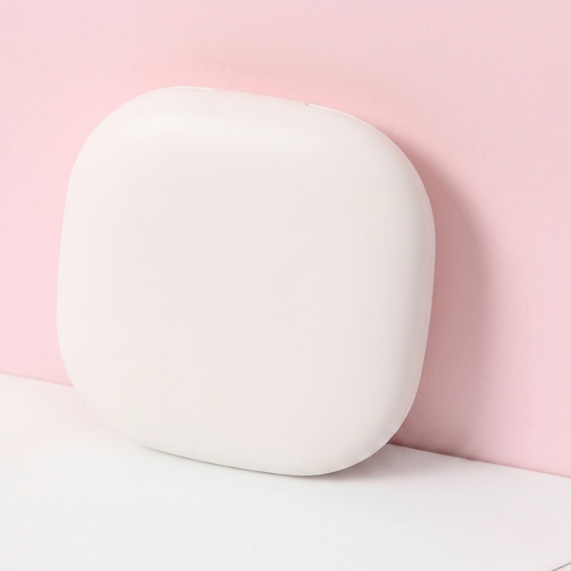 White round object on a pink background