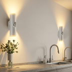 Modern kitchen with wall lights, sink, and decorative vase with flowers.