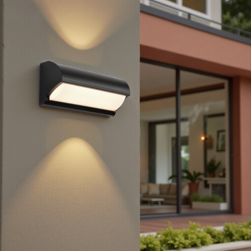Modern outdoor wall light fixture on a building exterior with a blurred indoor scene in the background.