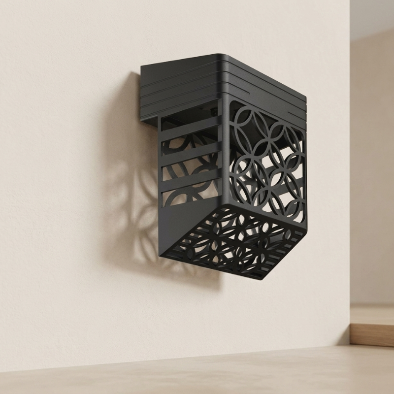 Black wall-mounted decorative bracket on a beige wall
