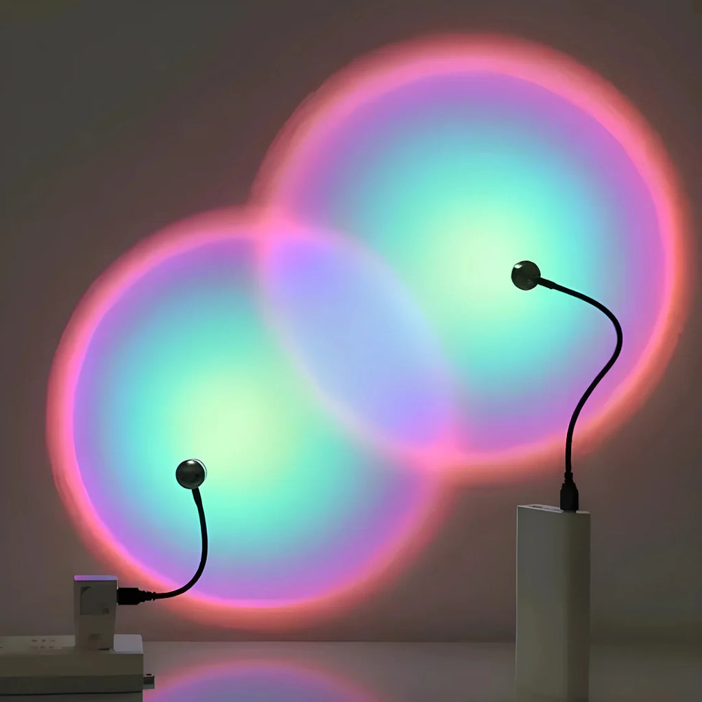 Colorful circular light projections on a wall with two black lamps emitting the light.