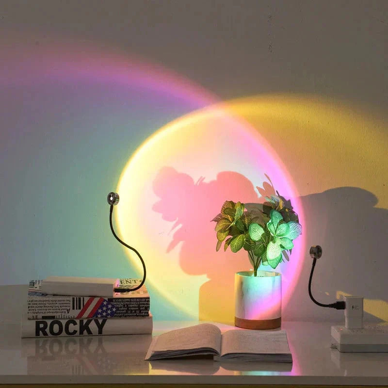 Colorful light projection on a wall with books and a plant in the foreground.