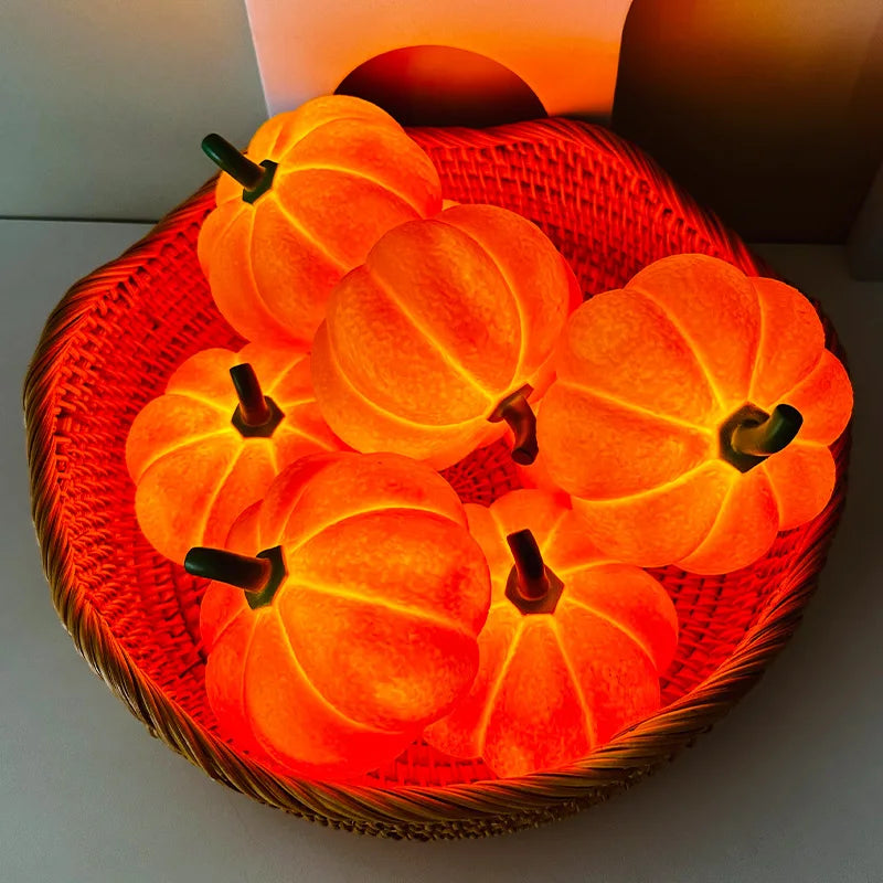 Decorative orange pumpkins with green stems in a woven basket on a white background