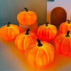 Group of glowing orange pumpkin lights on a neutral background