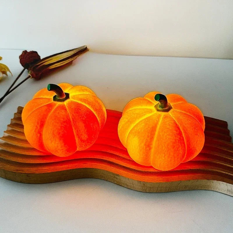 Two glowing orange pumpkins on a wooden stand with a white background