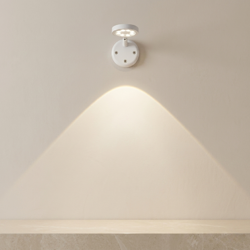 Wall-mounted light fixture casting a warm glow on a neutral wall.