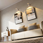 Modern living room with a beige sofa, side table, and wall art.