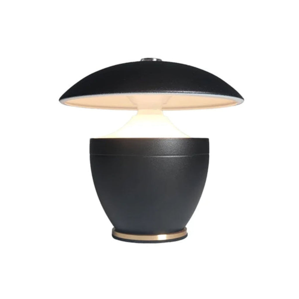 Black table lamp with a round base and flat top on a white background