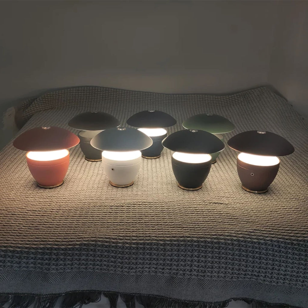 Set of small, colorful lamps on a textured surface with a dark background