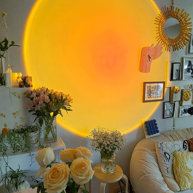Living room with a large circular light fixture, flowers, and decorative items.