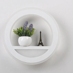 Decorative shelf with a potted plant and a small model of the Eiffel Tower against a white background