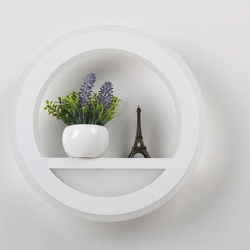 Decorative shelf with a potted plant and a small model of the Eiffel Tower against a white background