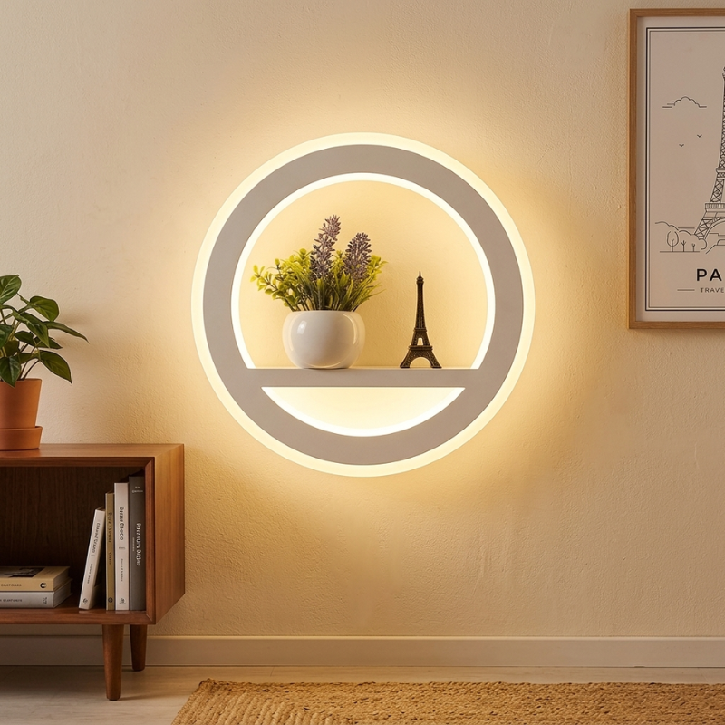 Round wall light fixture with a shelf displaying plants and a small statue, in a room setting.