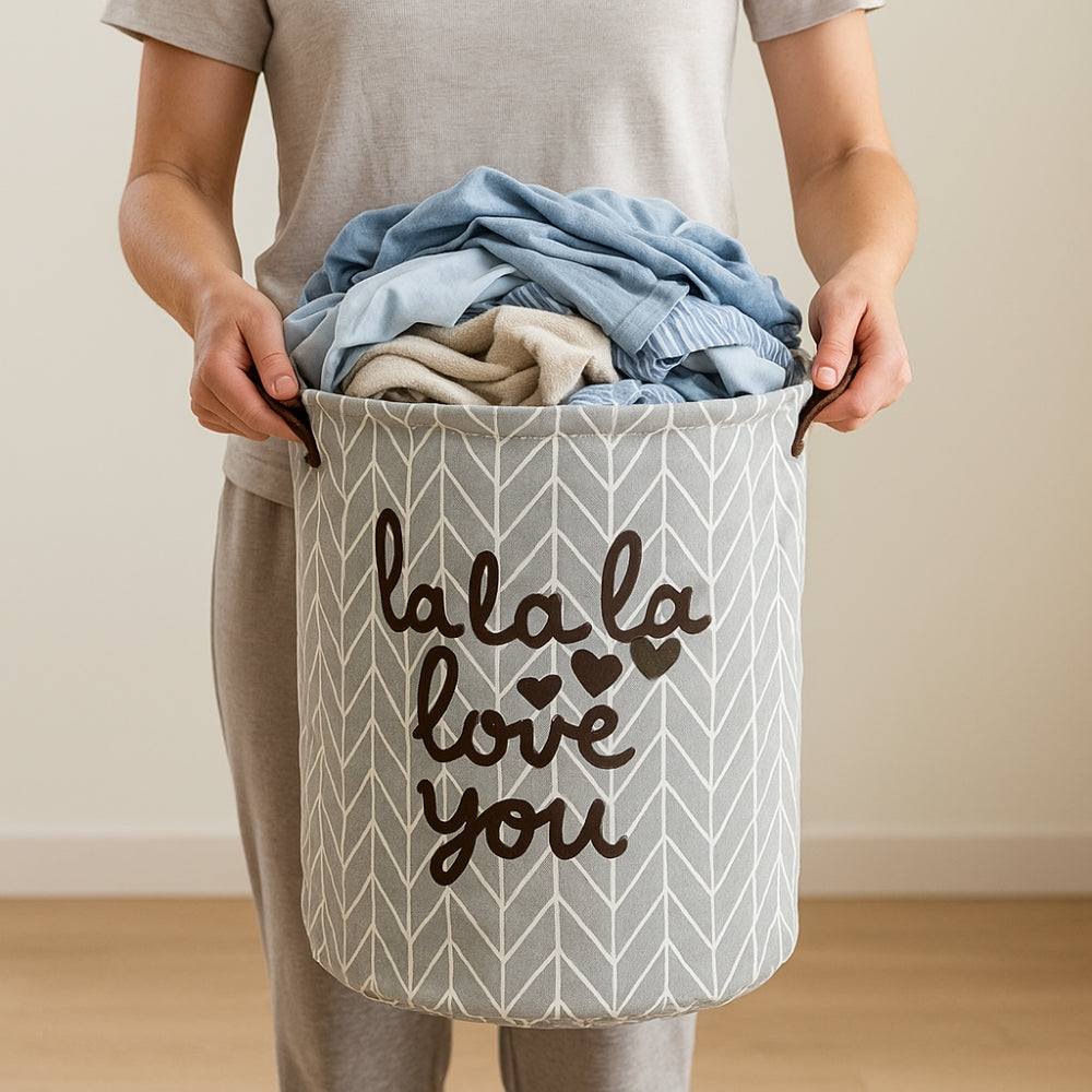 Person holding a laundry basket with clothes and 'lala la love you' text.