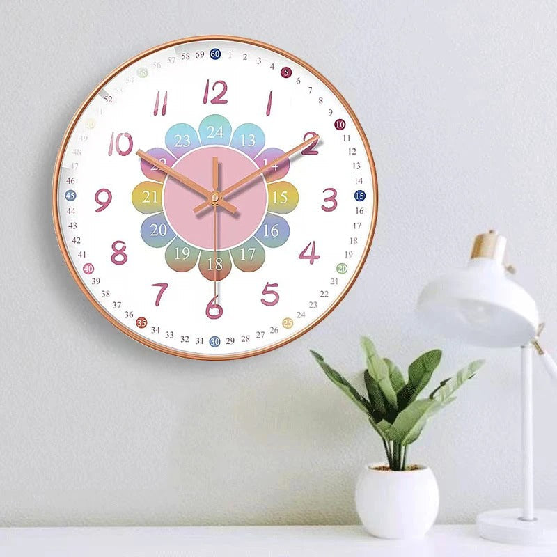 Colorful wall clock on a white wall with a plant and lamp in the background