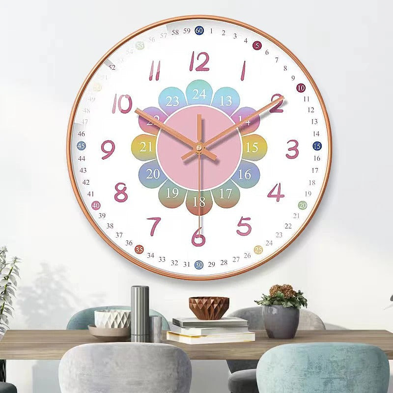 Colorful wall clock on a white wall above a dining table with decor items.