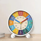 Colorful clock with a white frame on a wooden surface