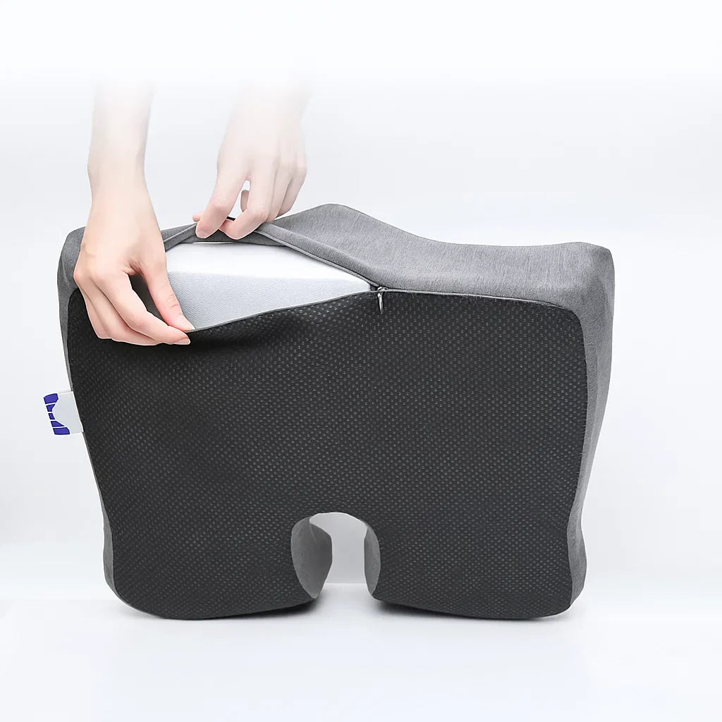 Gray and black cushion with a person holding it on a white background