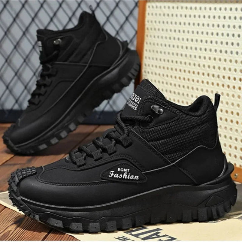 Black sneakers with 'EGMT Fashion' branding on a wooden floor.