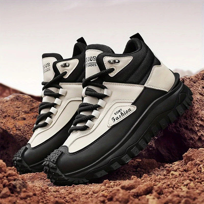 Black and white hiking boots on a rocky surface