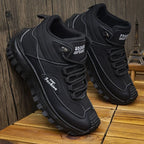 Black athletic shoes with brand name on wooden surface