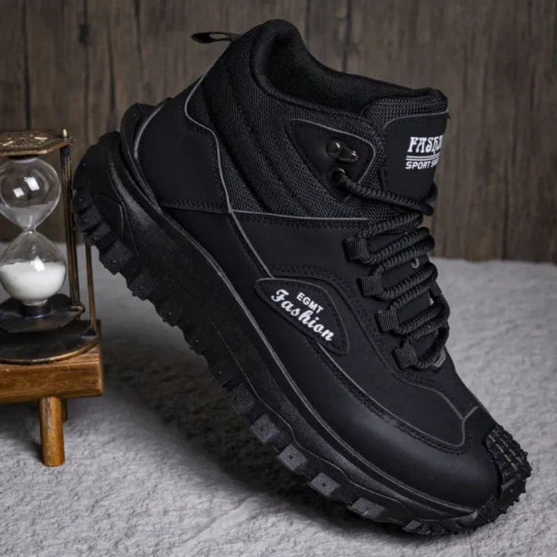 Black high-top sneaker with brand logo on a textured surface