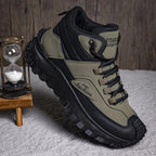 Green and black hiking boot on a textured surface with a wooden hourglass in the background