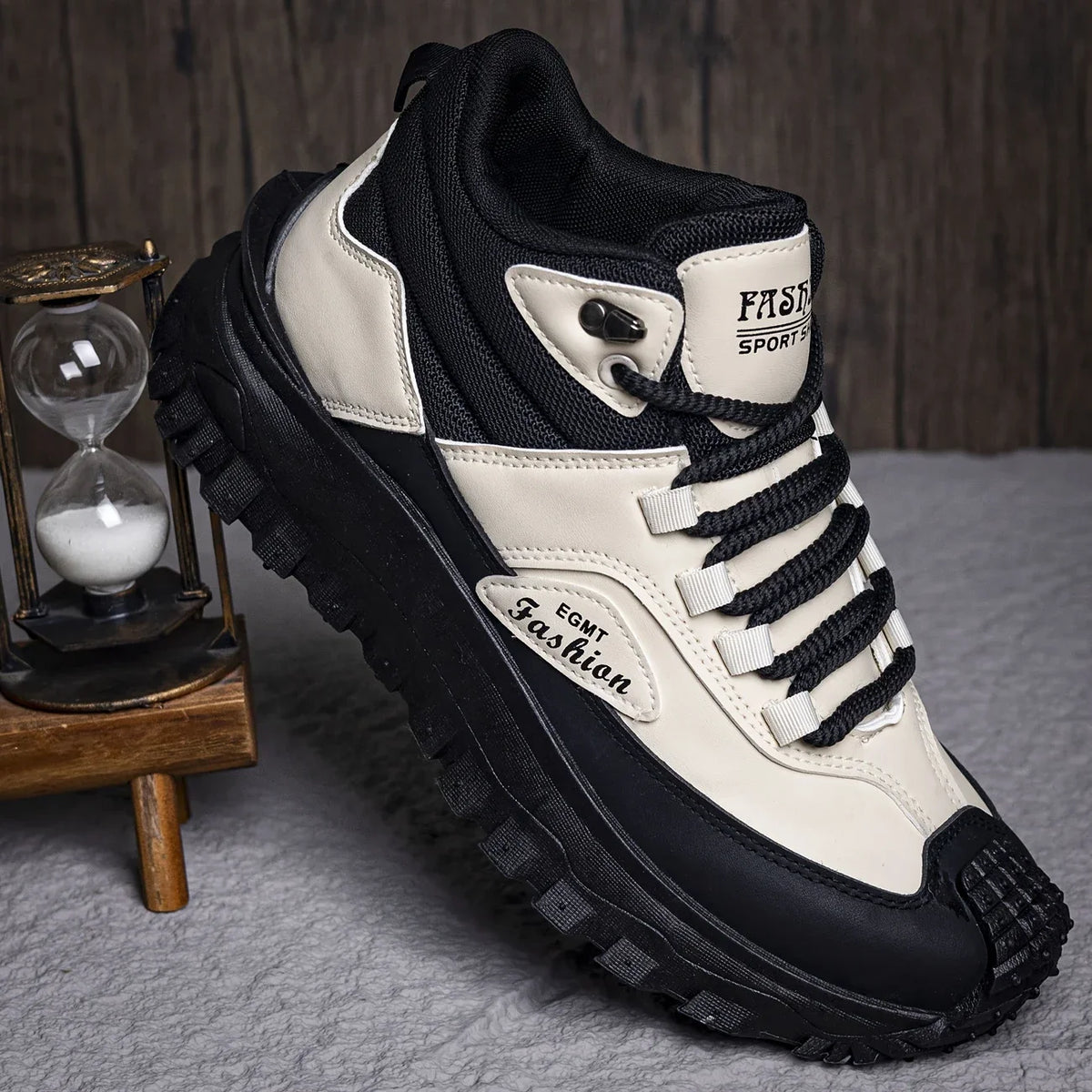 Black and white sneaker with visible branding on a gray surface.