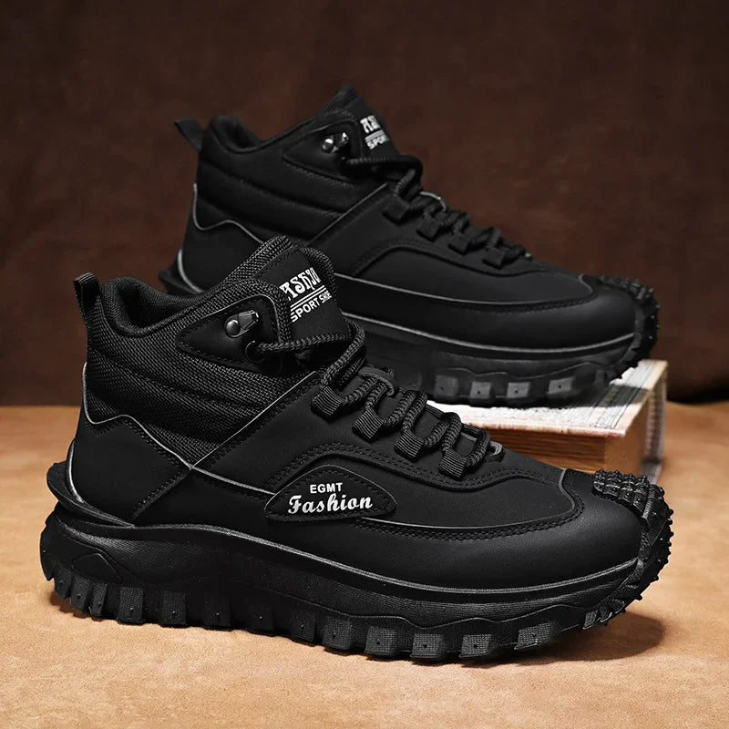 Black high-top sneakers with 'eamt Fashion' branding on a brown surface.