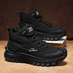 Black high-top sneakers with 'eamt Fashion' branding on a brown surface.