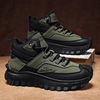 Green and black hiking boots on a brown surface with a dark background