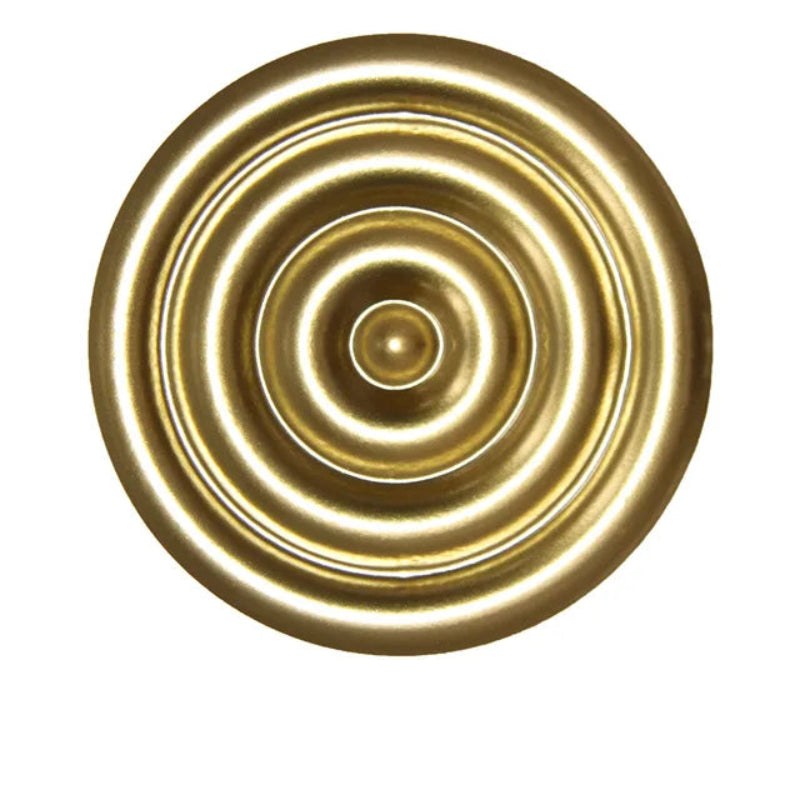 Gold circular decorative element with concentric rings on a white background