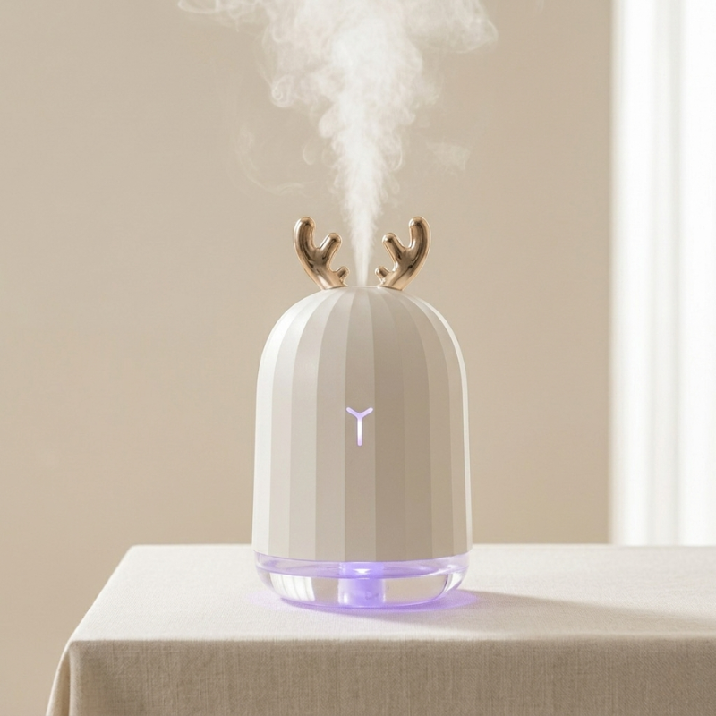 White humidifier with deer antler design on a beige surface