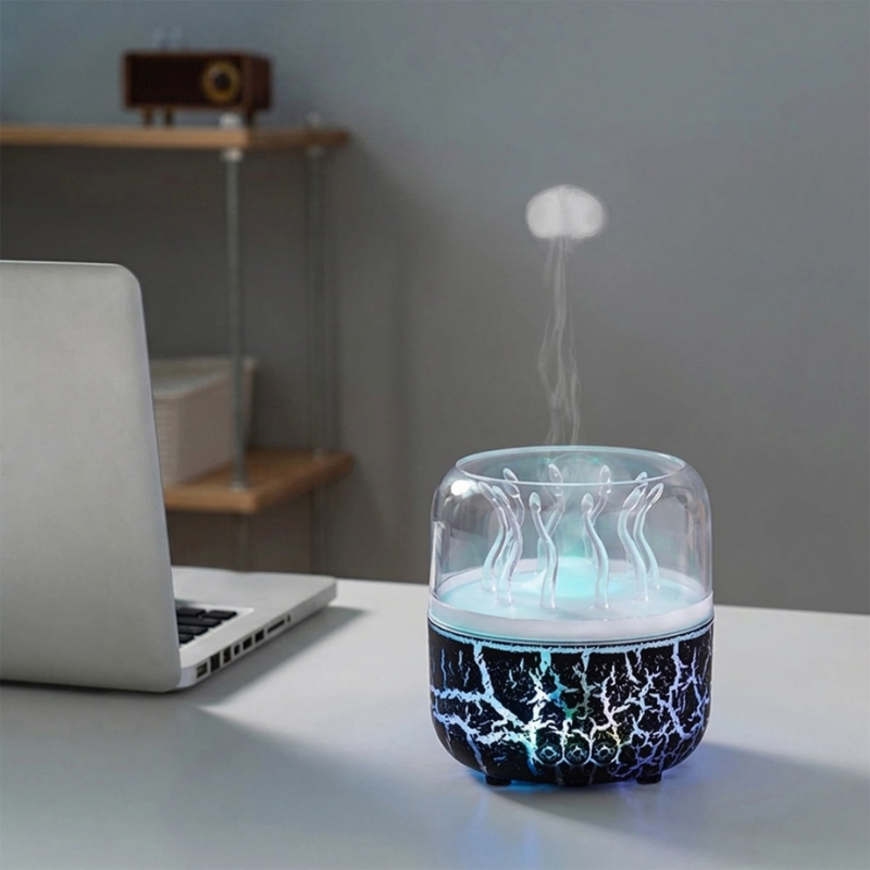 Humidifier emitting mist on a desk with a laptop in the background